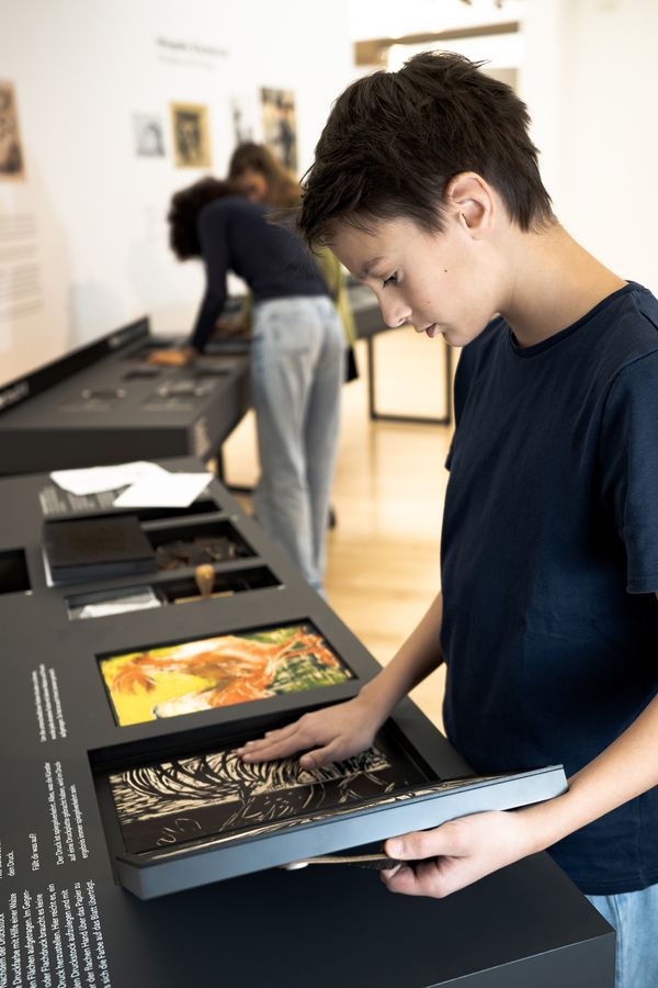 Visitor learn more about woodcut techniques by touch. Photo: Studio 3x3